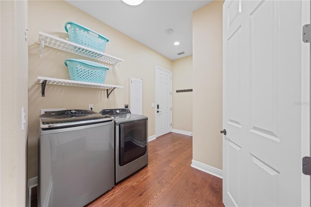 washroom featuring hardwood / wood-style floors and independent washer and dryer