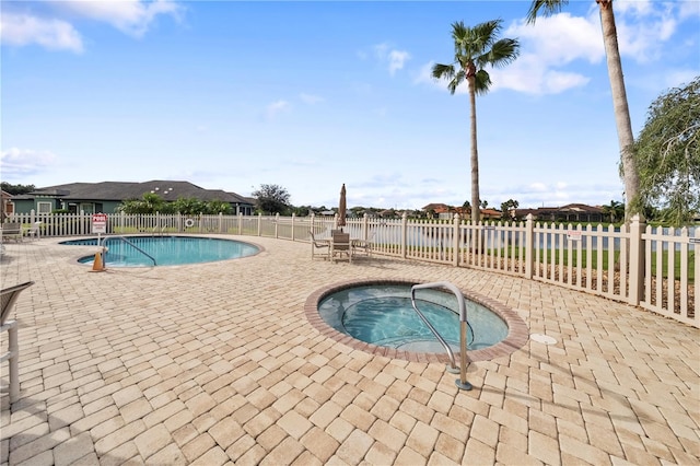 view of swimming pool featuring a community hot tub and a patio