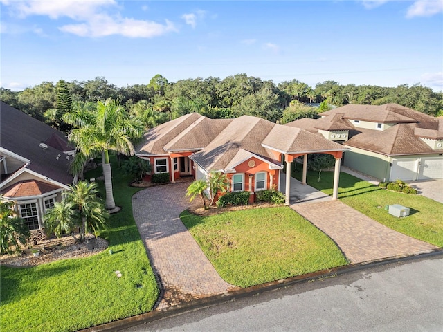 view of front of house with a carport and a front lawn