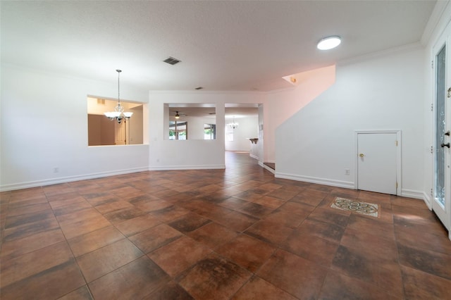 unfurnished living room featuring ceiling fan with notable chandelier and ornamental molding