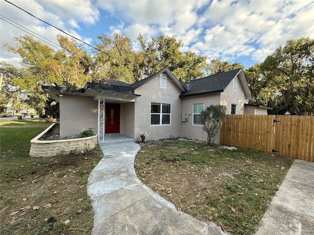 ranch-style house with a front lawn