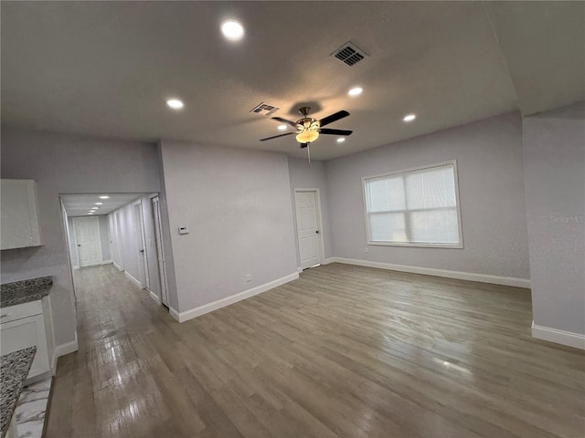 unfurnished living room featuring hardwood / wood-style flooring and ceiling fan