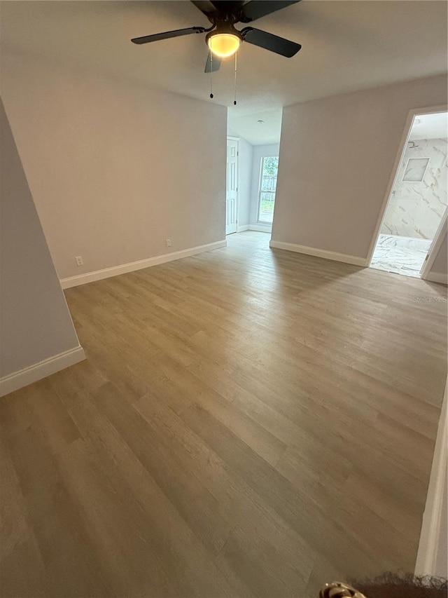 unfurnished room featuring hardwood / wood-style flooring and ceiling fan