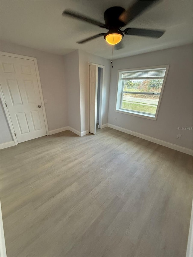 unfurnished bedroom featuring light hardwood / wood-style floors and ceiling fan