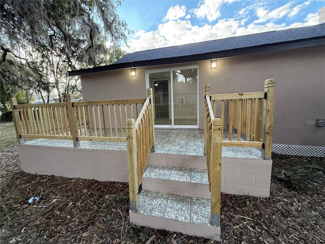 entrance to property with a deck