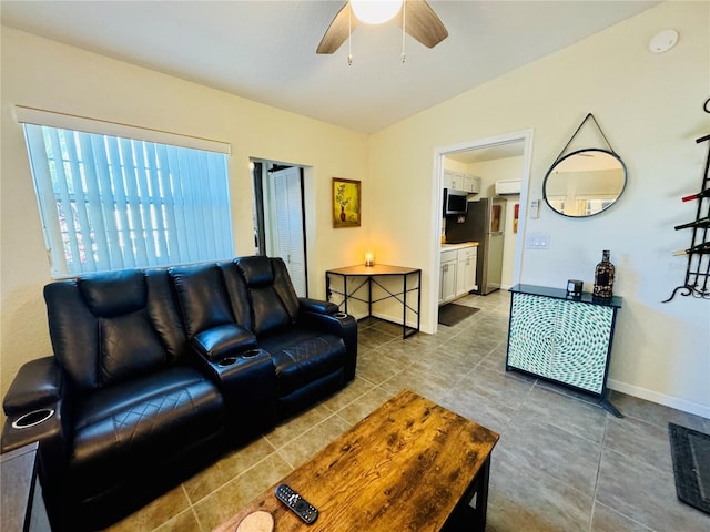 living room featuring tile patterned floors, ceiling fan, and lofted ceiling