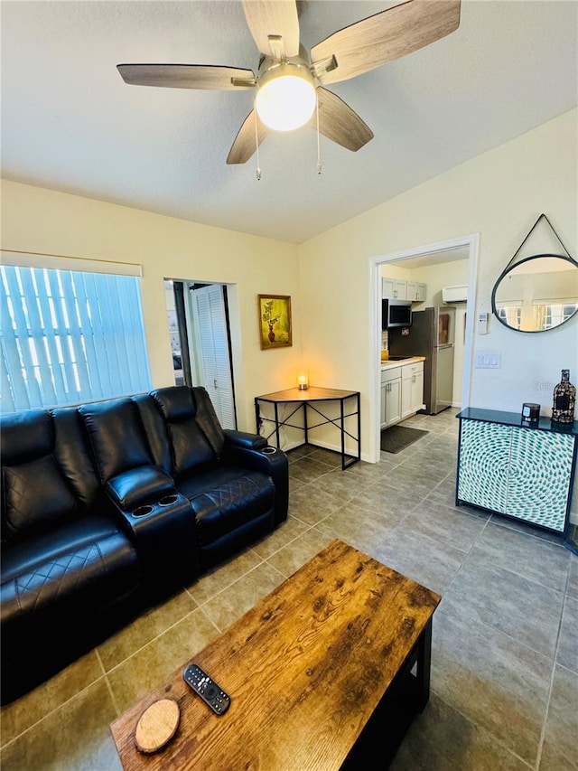 living room featuring tile patterned floors and ceiling fan