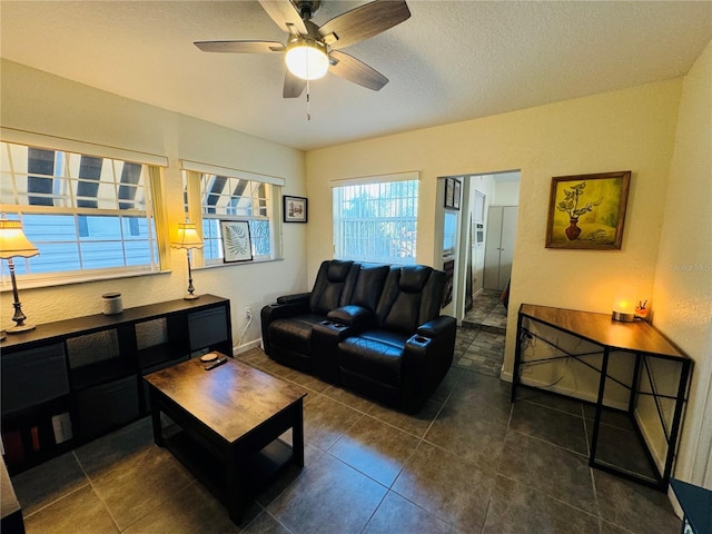 tiled living room with a textured ceiling and ceiling fan