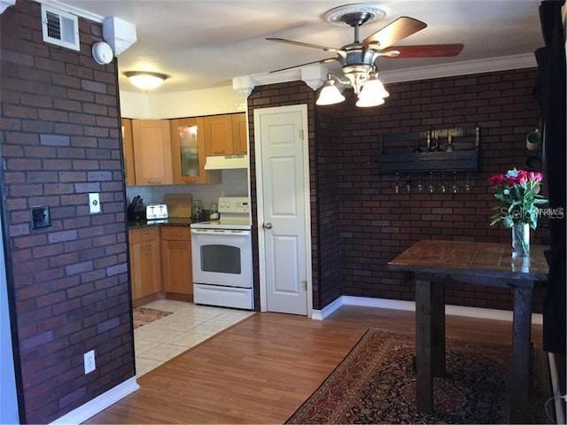 kitchen featuring ornamental molding, brick wall, ceiling fan, light hardwood / wood-style flooring, and white electric stove