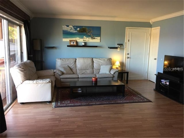 living room with hardwood / wood-style flooring and ornamental molding