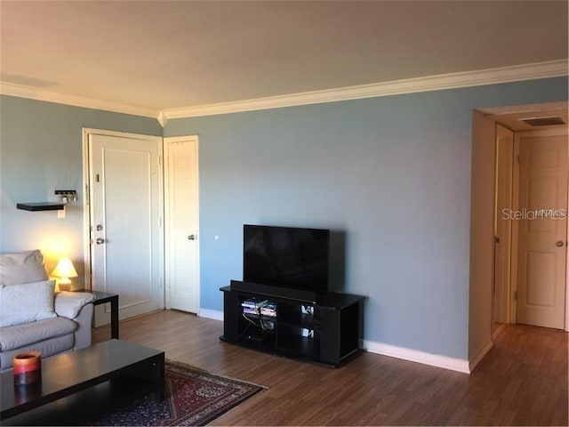 living room featuring dark hardwood / wood-style flooring and crown molding