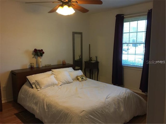 bedroom featuring ceiling fan and hardwood / wood-style flooring