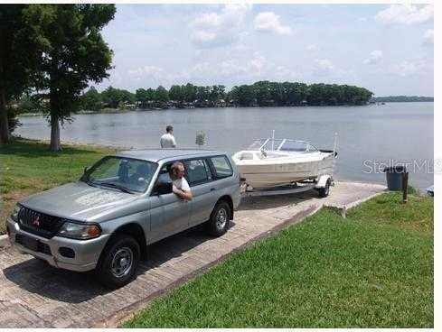 dock area featuring a water view and a lawn