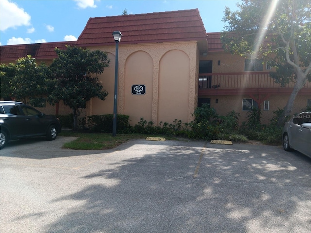 view of building exterior with uncovered parking