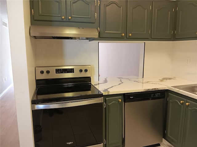 kitchen with tasteful backsplash, light stone countertops, stainless steel appliances, ventilation hood, and a sink