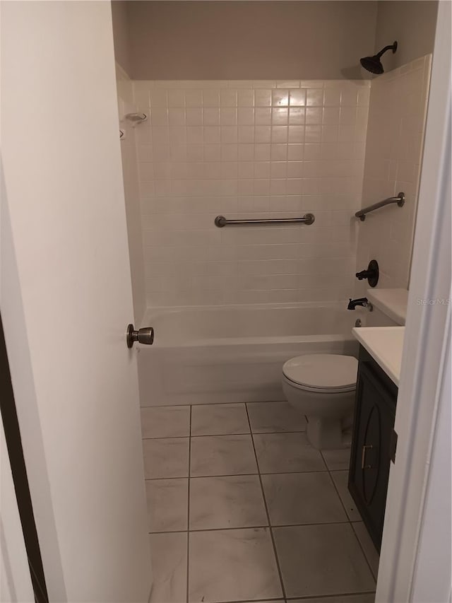 bathroom featuring toilet, tile patterned flooring, washtub / shower combination, and vanity