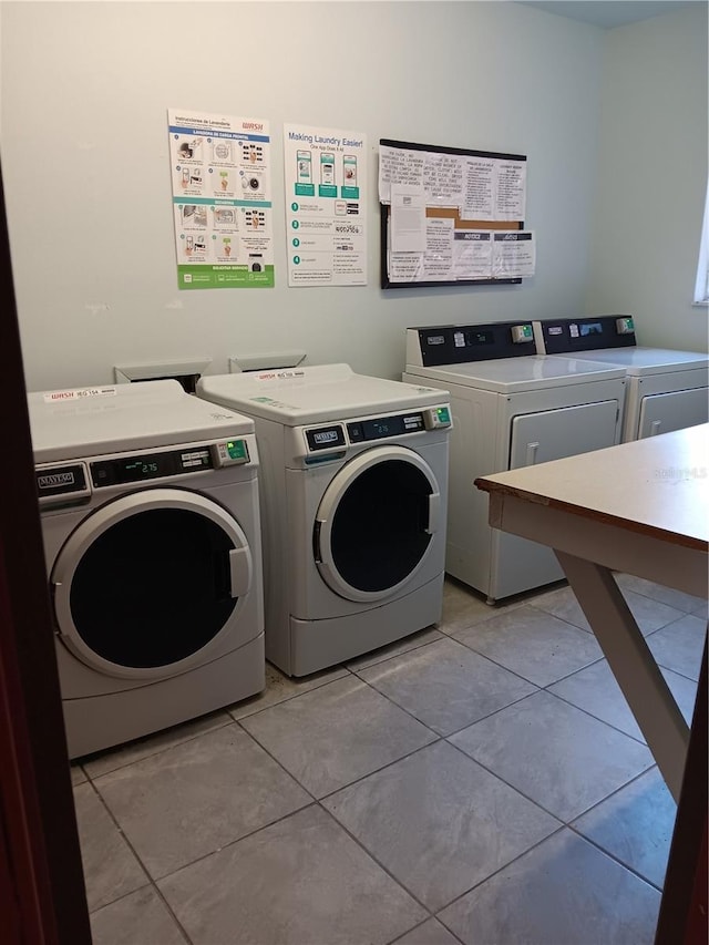 common laundry area featuring light tile patterned floors and separate washer and dryer