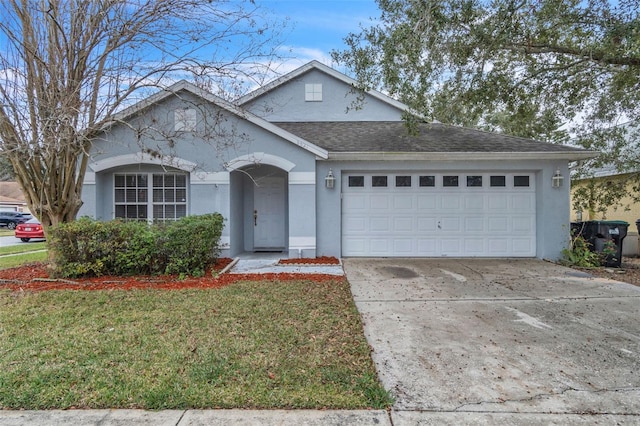 ranch-style home with a garage and a front yard