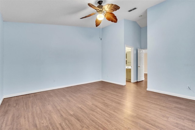 unfurnished room featuring hardwood / wood-style flooring, ceiling fan, and vaulted ceiling