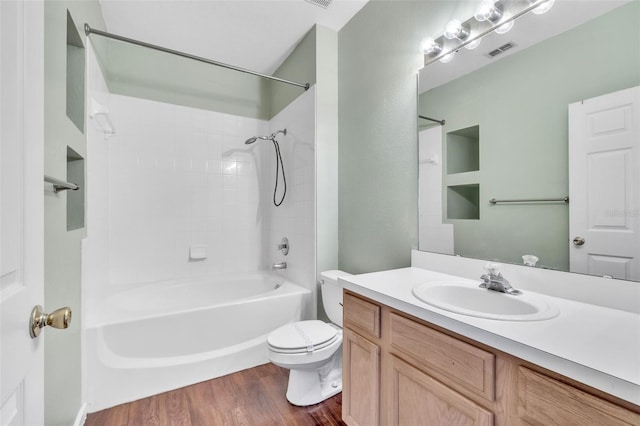 full bathroom with wood-type flooring, toilet, bathing tub / shower combination, and vanity