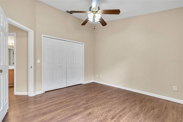 unfurnished bedroom with hardwood / wood-style floors, a closet, and ceiling fan