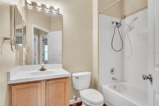 full bathroom with vanity, tiled shower / bath, and toilet