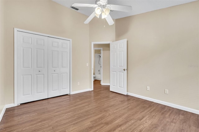 unfurnished bedroom with ceiling fan, a closet, and light wood-type flooring