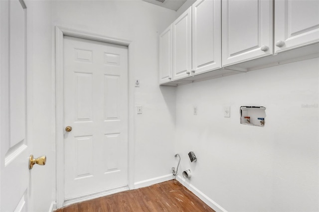 laundry room with washer hookup, dark hardwood / wood-style flooring, cabinets, and gas dryer hookup