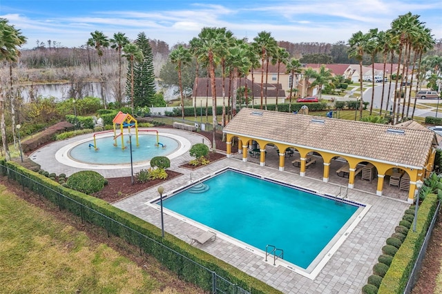 view of swimming pool featuring a water view and a patio area