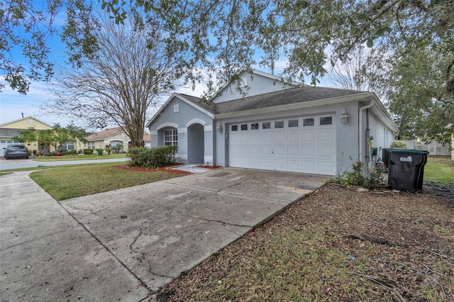 ranch-style house with a garage and a front lawn