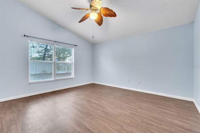 unfurnished room with lofted ceiling, wood-type flooring, and ceiling fan