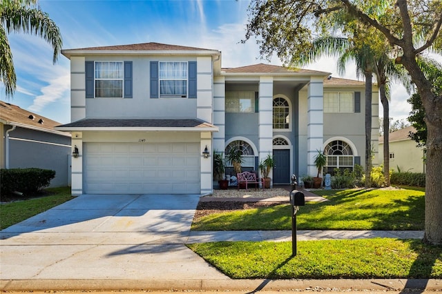 view of front facade featuring a garage and a front lawn