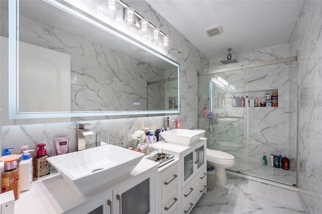 bathroom with vanity, a shower with shower door, tile walls, and toilet