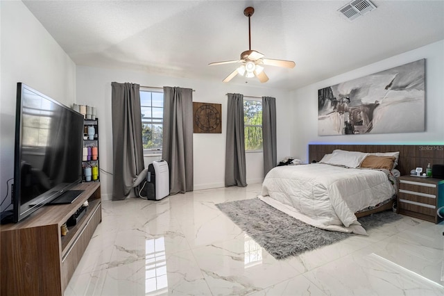 bedroom with ceiling fan and multiple windows