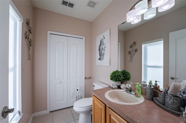 bathroom featuring tile patterned flooring, vanity, and toilet