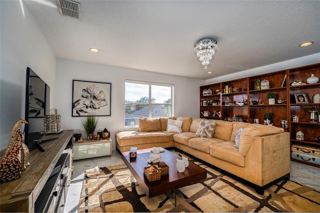 living room with a textured ceiling and a notable chandelier