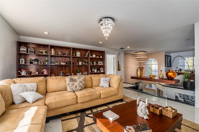 living room with a notable chandelier and a textured ceiling