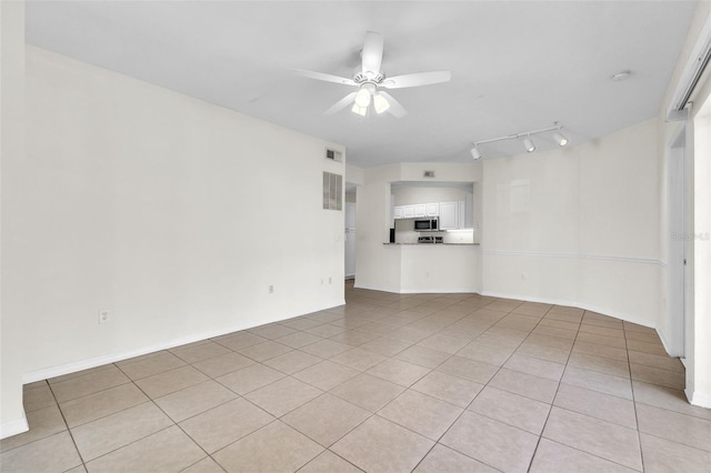 unfurnished living room featuring light tile patterned floors and ceiling fan