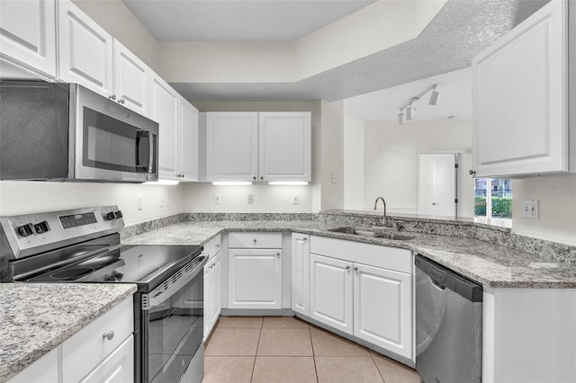 kitchen featuring white cabinetry, appliances with stainless steel finishes, sink, and track lighting