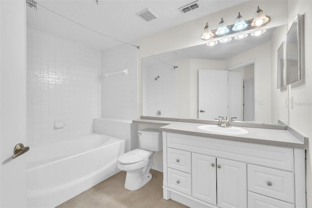 full bathroom featuring tiled shower / bath, vanity, toilet, and tile patterned floors