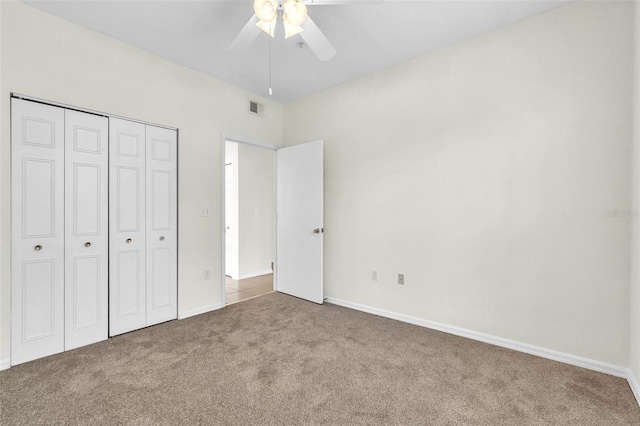 unfurnished bedroom with ceiling fan, carpet floors, and a closet