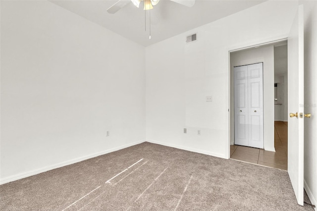 empty room with ceiling fan and carpet