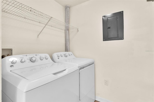 clothes washing area with separate washer and dryer and electric panel