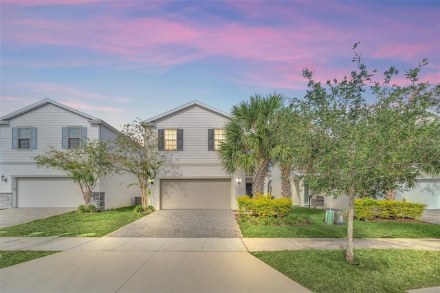 view of front of house with a yard and a garage