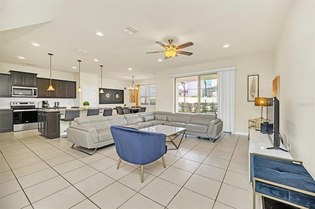 living room with ceiling fan and light tile patterned flooring