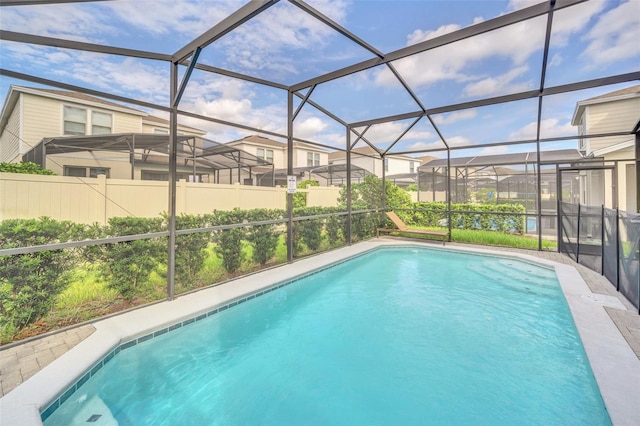 view of swimming pool with glass enclosure