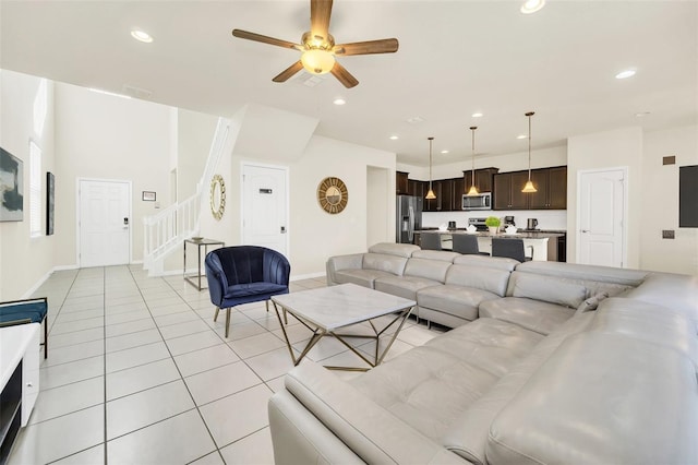 2468 Dubai St, Kissimmee, FL 34747 - living room featuring stairs, ceiling fan, light tile patterned floors, and recessed lighting