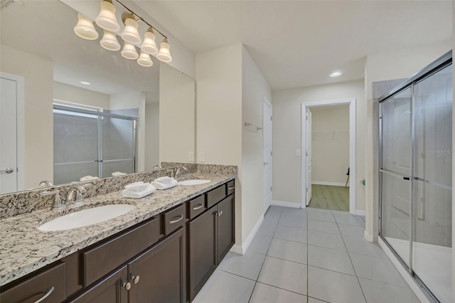 bathroom featuring vanity, tile patterned floors, and a shower with door