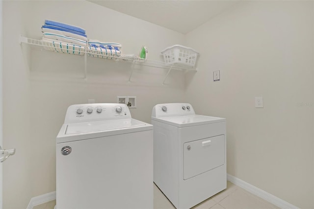 laundry room featuring light tile patterned floors and independent washer and dryer