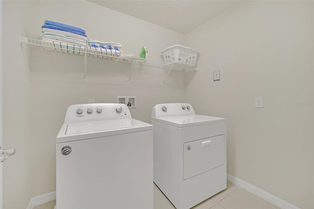 2468 Dubai St, Kissimmee, FL 34747 - washroom with separate washer and dryer and light tile patterned floors